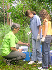 Chris Milne showing students how to measure water turbidity